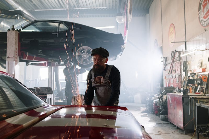 Mechanic working on a classic car in the shop