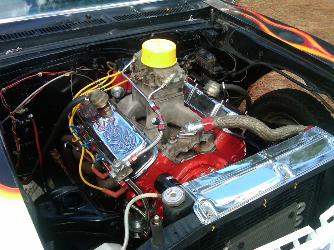 Race-ready engine bay with chrome valve covers and headers
